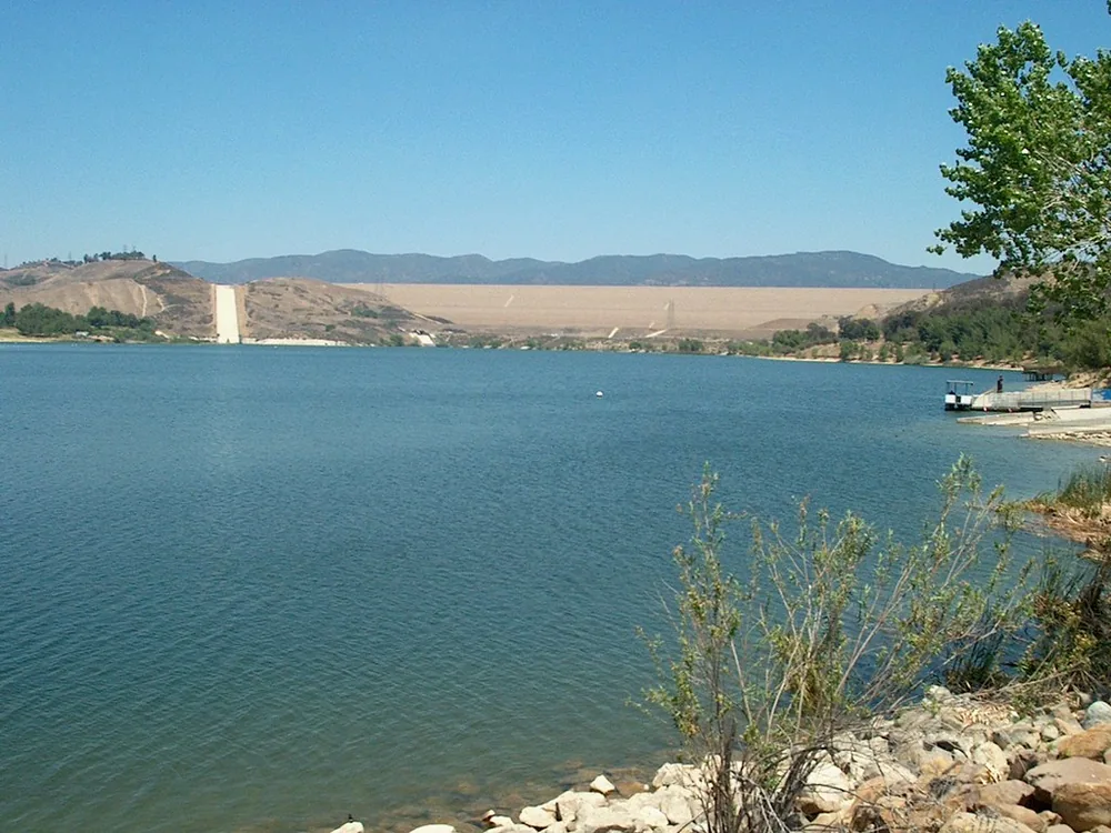 Castaic Lagoon with the long earthen Castaic Dam and its spillway behind the water
