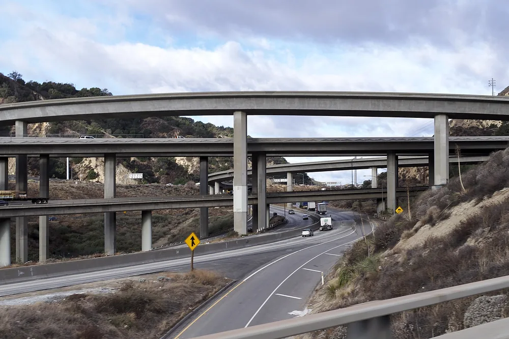 Stacked freeway ramps of a large highway interchange in a hilly pass